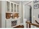 Stylish wet bar features a wine rack, display cabinets, and a tiled backsplash at 2115 Howell Mill Nw Rd, Atlanta, GA 30318