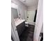 Basic bathroom featuring a tub-shower combo and gray vanity as viewed through the doorway at 4312 Idlewood Ln, Tucker, GA 30084
