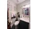 Cozy bathroom featuring an elegant vanity and toilet, complemented by stylish wall art at 4312 Idlewood Ln, Tucker, GA 30084