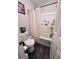 Simple bathroom showcasing a shower with patterned curtain and a uniquely decorated toilet at 4312 Idlewood Ln, Tucker, GA 30084