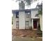 Charming two-story home with red front door and neutral siding offers a cozy curb appeal at 4312 Idlewood Ln, Tucker, GA 30084