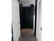 Hallway with a striking black barn door and two white paneled doors at 4312 Idlewood Ln, Tucker, GA 30084