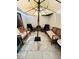 Enclosed patio with modern tile flooring, comfortable seating and umbrella with string lights at 4312 Idlewood Ln, Tucker, GA 30084