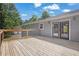 Expansive wooden deck perfect for outdoor entertaining, with access to the home's interior and views of the backyard at 4070 Feather Dr, Douglasville, GA 30135