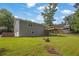 View of the backyard, including the deck, garage, and lush lawn of this charming home at 4070 Feather Dr, Douglasville, GA 30135
