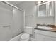 A bathroom featuring a shower with glass doors, a toilet, and vanity with a sink and cabinet at 4070 Feather Dr, Douglasville, GA 30135