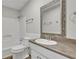 Bathroom with white wainscoting, toilet and vanity with decorative mirror at 4070 Feather Dr, Douglasville, GA 30135