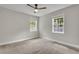 A cozy bedroom with neutral carpet, two windows, and a ceiling fan at 4070 Feather Dr, Douglasville, GA 30135