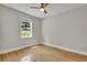 The bedroom offers hardwood floors, a ceiling fan and a large window at 4070 Feather Dr, Douglasville, GA 30135