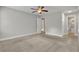 Large primary bedroom features neutral carpet and paint and an ensuite bathroom at 4070 Feather Dr, Douglasville, GA 30135
