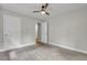 Bedroom with neutral carpet, ceiling fan and two doors at 4070 Feather Dr, Douglasville, GA 30135