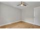 A bedroom with hardwood floors, a ceiling fan, and a door at 4070 Feather Dr, Douglasville, GA 30135