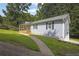 Well-manicured lawn leading to the home's side entrance, highlighting the clean lines and landscaping at 4070 Feather Dr, Douglasville, GA 30135