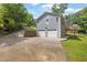 View of the two-car garage, driveway, and side deck of this charming home at 4070 Feather Dr, Douglasville, GA 30135
