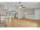 Open-concept living area with hardwood floors, a stone fireplace, and access to a deck, offering seamless indoor-outdoor living at 4070 Feather Dr, Douglasville, GA 30135