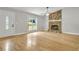 Bright living room featuring hardwood floors, a stone fireplace, and ample natural light from a large window at 4070 Feather Dr, Douglasville, GA 30135