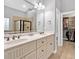 Bright bathroom featuring double sinks, a large mirror, and a shower with glass enclosure at 7030 Mandevilla Ln, Douglasville, GA 30135