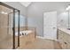Bright bathroom with a soaking tub and glass shower enclosure at 7030 Mandevilla Ln, Douglasville, GA 30135