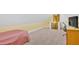 Spacious carpeted bonus room with a bed, desk, and TV at 7030 Mandevilla Ln, Douglasville, GA 30135