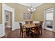 Traditional dining room featuring wood table, chandelier, and natural lighting at 7030 Mandevilla Ln, Douglasville, GA 30135
