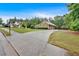 Charming home showcasing well-manicured lawn, mature trees, circular driveway, and inviting front porch at 7030 Mandevilla Ln, Douglasville, GA 30135
