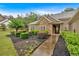 Charming single-story home featuring manicured front lawn and stone-accented entrance with tasteful landscaping at 7030 Mandevilla Ln, Douglasville, GA 30135