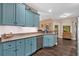 Bright kitchen with light blue cabinets, granite countertops, and stainless steel appliances at 7030 Mandevilla Ln, Douglasville, GA 30135