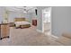 Spacious main bedroom featuring a tray ceiling, ceiling fan, sitting area, and attached bathroom at 7030 Mandevilla Ln, Douglasville, GA 30135