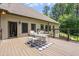 Back deck with outdoor seating and dining area, perfect for entertaining, with a backyard view at 799 Wagon Trl, Woodstock, GA 30188