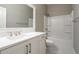 Well-lit bathroom featuring a white vanity with a large mirror and a shower-tub combination at 799 Wagon Trl, Woodstock, GA 30188
