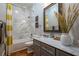 Bathroom featuring marble tiling in the shower, and a gray vanity with chrome fixtures at 799 Wagon Trl, Woodstock, GA 30188