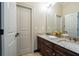 Bathroom featuring a double vanity with stone countertop, dark wood cabinets, and ample storage at 799 Wagon Trl, Woodstock, GA 30188