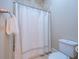 Bathroom showcasing a shower with a curtain and a toilet with neutral color at 799 Wagon Trl, Woodstock, GA 30188
