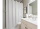 Bathroom showcasing a vanity with a shower curtain, painting and light fixture at 799 Wagon Trl, Woodstock, GA 30188
