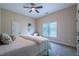 Bedroom with carpet, neutral walls, ceiling fan, and a white framed window at 799 Wagon Trl, Woodstock, GA 30188
