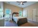 Bedroom with carpet, neutral walls, ceiling fan, and white trim around the windows and doors at 799 Wagon Trl, Woodstock, GA 30188