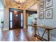 Elegant foyer boasts hardwood floors, a statement door, and designer touches setting a welcoming tone at 799 Wagon Trl, Woodstock, GA 30188
