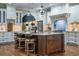Gourmet kitchen featuring an island with seating, stainless steel appliances, and custom cabinetry at 799 Wagon Trl, Woodstock, GA 30188