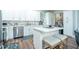 Modern kitchen featuring white cabinets, stainless steel appliances, and a center island with seating at 799 Wagon Trl, Woodstock, GA 30188