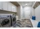 Laundry room featuring a side-by-side washer and dryer and built-in cabinets at 799 Wagon Trl, Woodstock, GA 30188