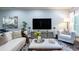 Comfortable living room with hardwood floors, a white sofa, large TV, and light gray walls at 799 Wagon Trl, Woodstock, GA 30188