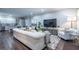 Spacious living room with hardwood floors, a white sofa, and large TV at 799 Wagon Trl, Woodstock, GA 30188