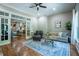 Open-concept living room featuring hardwood floors, decorative rug, and large doorways at 799 Wagon Trl, Woodstock, GA 30188