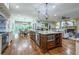 Open floor plan with chef's kitchen, dining area, and living room with stone fireplace at 799 Wagon Trl, Woodstock, GA 30188