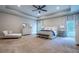 Large main bedroom with plush carpet, chaise lounge, and abundant natural light at 799 Wagon Trl, Woodstock, GA 30188