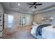 Bright main bedroom featuring plush carpet, tray ceiling, and ample closet space at 799 Wagon Trl, Woodstock, GA 30188