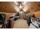 Spacious attic filled with an assortment of items, wood paneling, and a ceiling fan at 1104 Warrenhall Ne Ln, Brookhaven, GA 30319