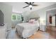 Bedroom with a ceiling fan, soft blue walls, a window and a view of the closet on the left at 1104 Warrenhall Ne Ln, Brookhaven, GA 30319
