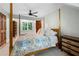 Bedroom featuring a four-poster bed, a ceiling fan, dresser and a view through the window at 1104 Warrenhall Ne Ln, Brookhaven, GA 30319