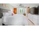 Well-lit bedroom featuring a ceiling fan, neutral walls, a bed with white bedding and light-colored trim at 1104 Warrenhall Ne Ln, Brookhaven, GA 30319